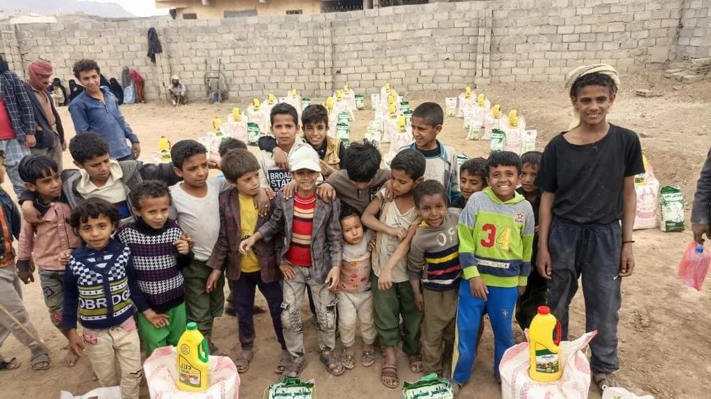 Children receiving food aid packages from Human Relief Appeal